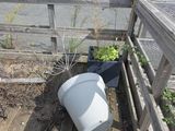 a white bucket sitting on a wooden deck next to a white van