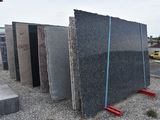 a pile of granite blocks sitting on the side of the road