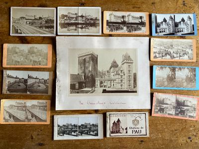 a lot of old postcards on a wooden table