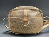 brown and tan cross body bag with monogramming on the front