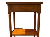 a small wooden table with a shelf underneath it