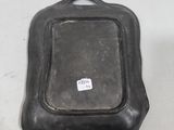 a black pan with a handle on a white table