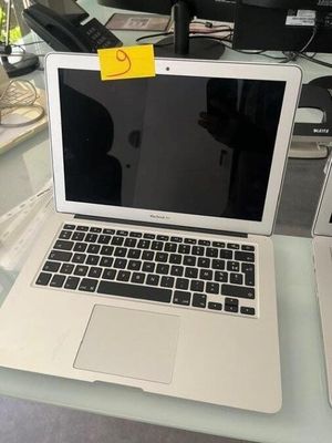 a laptop computer sitting on top of a glass table