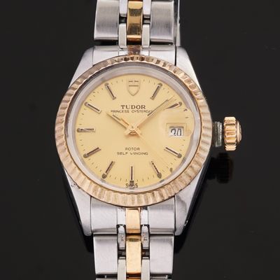 an image of a lady ' s rolex watch on a black surface