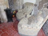 a picture of a living room with two chairs and a fire place