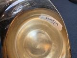 a person holding a silver cup with a sticker on it