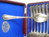 a lot of spoons that are in a blue box