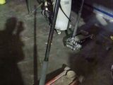 a motorcycle parked in a garage with tools on the floor