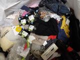 a pile of clothes and other items on a bed