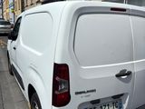 a white van that is parked on the side of the street