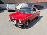 a red car that is parked in a parking lot