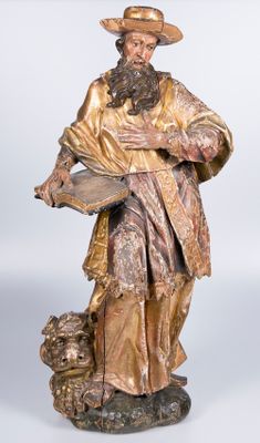 statue of a man with a beard and a hat holding a book and a dog