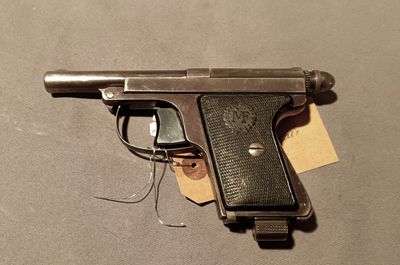 a gun that is laying on a table with a tag