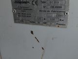 a white machine that has a metal label on it