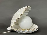 a white shell with a white ball inside of it