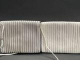 a white clutch bag on a black background
