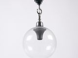 a close up of a clear glass light hanging from a ceiling