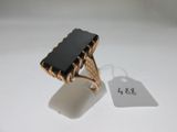 an image of a gold ring with a black stone on it