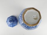 a blue and white vase and a blue and white salt shaker