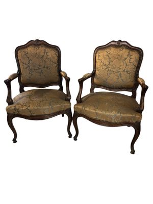 pair of antique carved wood chairs with upholstered upholstered seats