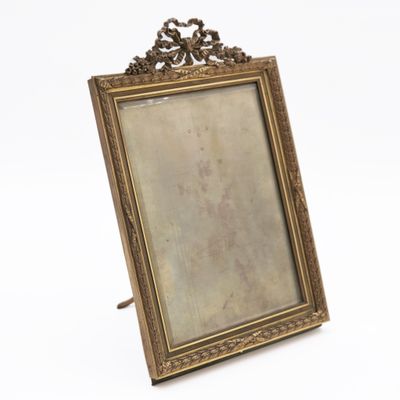 an old picture frame with a picture on it on a white surface