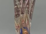 a glass vase that has a blue base and a gold base