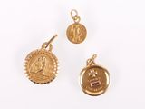three pieces of gold jewellery including a coin and a pendant