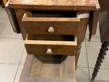a small wooden table with two drawers on it