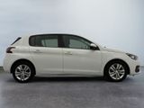 the white car is parked on the concrete floor in the room