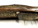 a close up of a rifle on a white surface