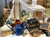 a table with a lot of items on it and a blue watering can