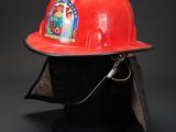 red fireman ' s hard hat on a black mannequin head