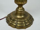a gold lamp that is on a white table