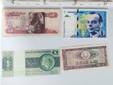 several different bank notes are hanging on a wall in a room