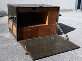a small wooden box with two drawers inside of it
