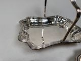 a silver plate with a spoon and a spoon holder