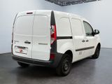 a white van parked in a room with a black floor