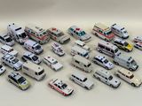 many different types of toy ambulances on the table
