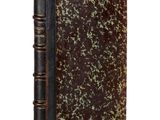 an old book with a brown cover sitting on top of a white surface
