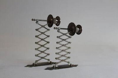 a metal sculpture of a pair of weights on a stand