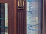 a glass display case with a clock on top of it