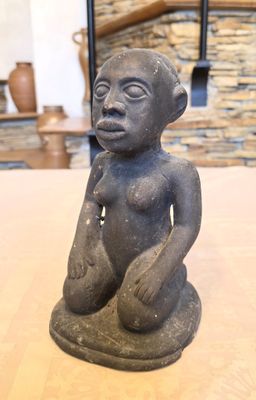 an image of a statue of a monkey sitting on a table