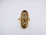 a close up of a gold ring on a white surface