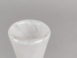 a white vase that has a brown stripe on it