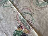 a white table cloth with a dragon design on it
