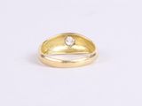 a gold ring with a diamond on top of it