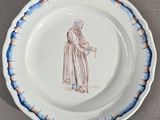 une assiette sur laquelle est représentée une femme tenant un panier
