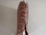 a pair of brown boots that have laces on them