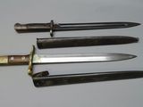 four different types of knives are displayed on a white surface