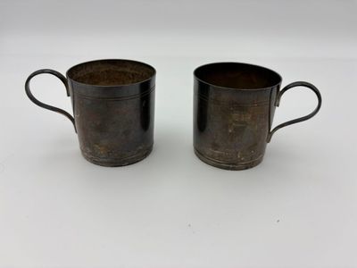 a pair of brown cups sitting on top of a white table